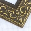 A large, reverse curve profile frame with an intricate leaf design bordered by a geometric outer edge and beaded inner lip.  A dark, matte gold-brown base with gold foil patina for added depth on the topmost points of the design. Strong, solid wood construction.

3.25 " witdth: ideal for large and oversize (extra large) images.